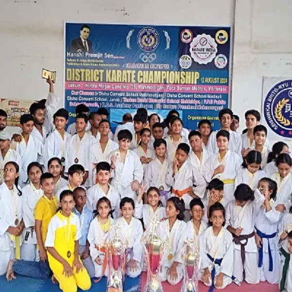 Group of students in karate uniforms posing with trophies at the District Karate Championship event held on 24 August 2024
